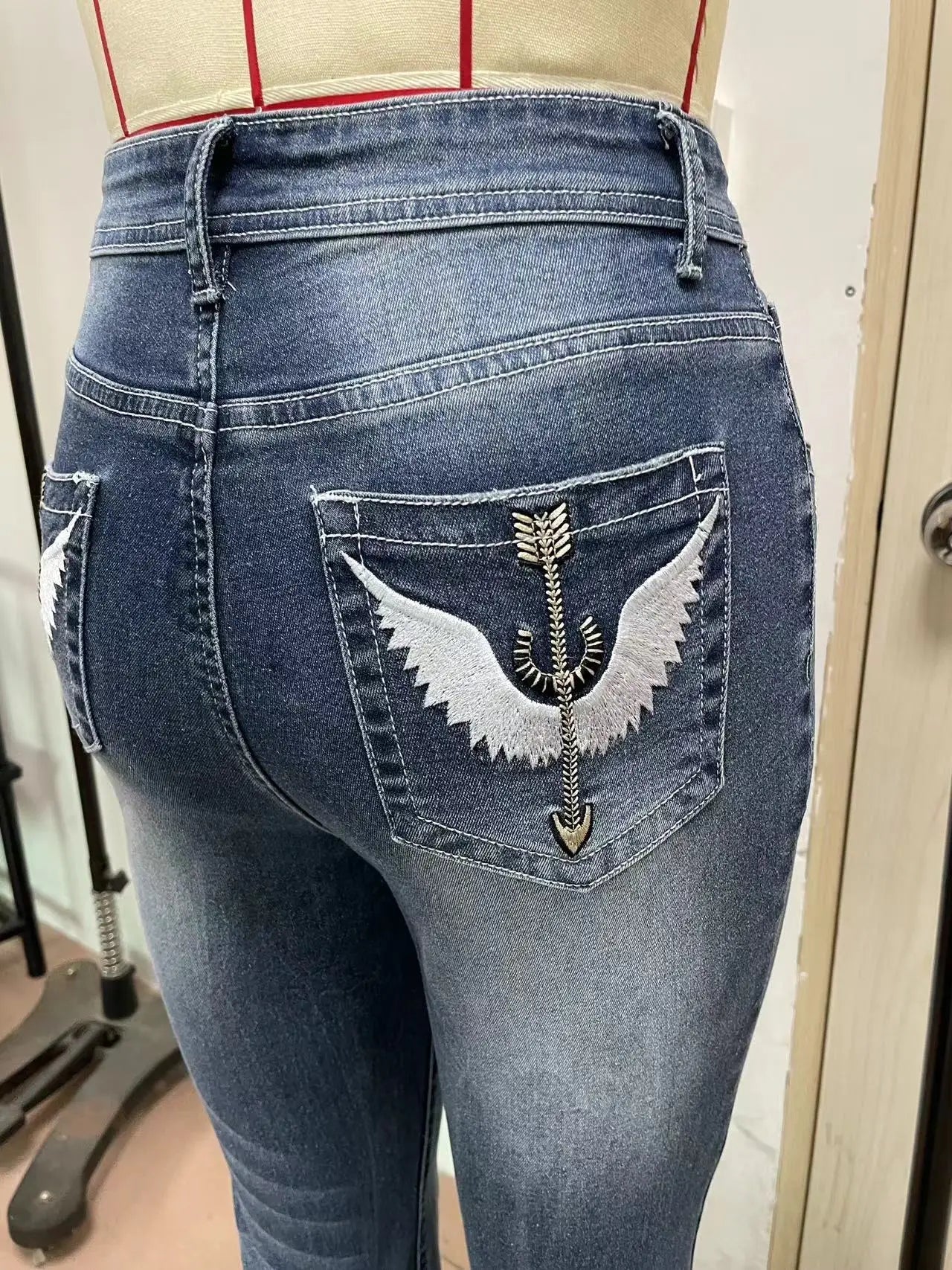 Women Embroidery Pockets Distressed Jeans Mid Waist Stretch Slim Fit Pants - American Thistle Women Embroidery Pockets Distressed Jeans Mid Waist Stretch Slim Fit Pants